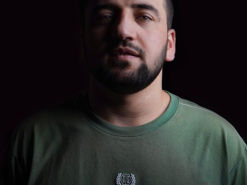 Silhouette of a man in a focused pose against a dark background.